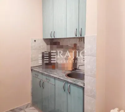 Small kitchen with light cabinets and a sink. - image 6