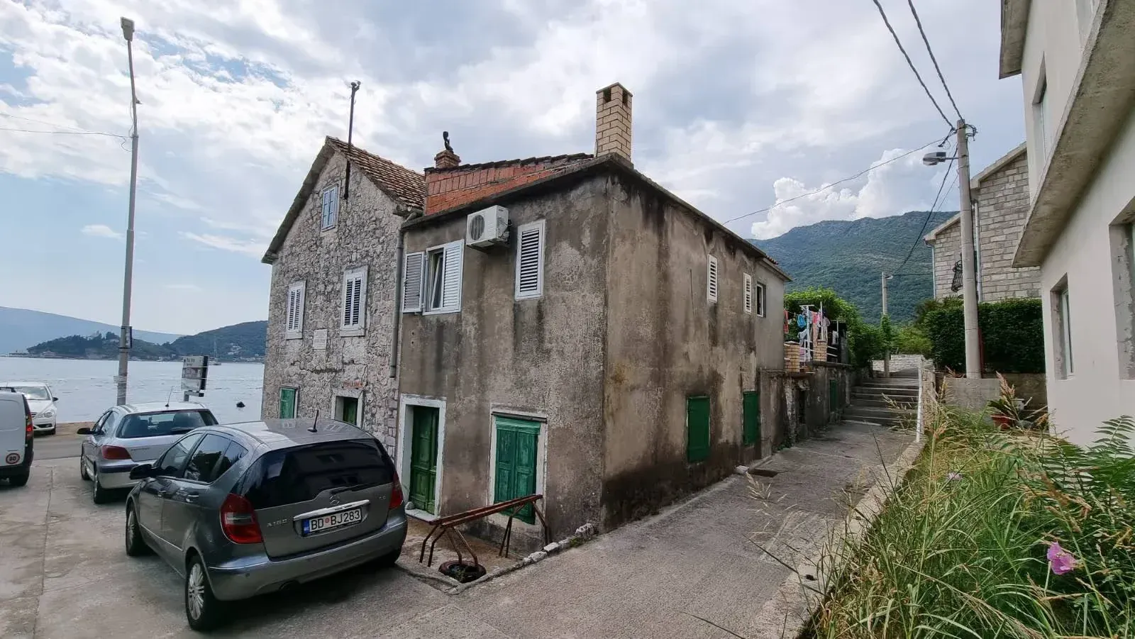 Pogled na spoljašnjost tradicionalne kamene kuće blizu obale.