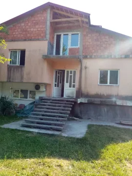 Exterior view of an unfinished two-story house with a yard. - image 7