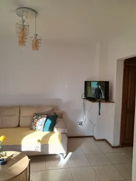 Living room with a sofa, coffee table, and wall-mounted TV. - image 4
