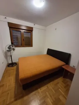 Bedroom with a double bed, parquet flooring, and a window with blinds. - image 5