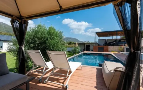 Yard with a swimming pool, sun loungers and surrounding view. - image 3
