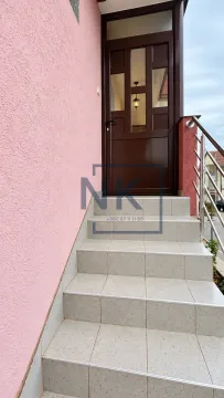 Entrance door with steps and a pink facade. - image 10
