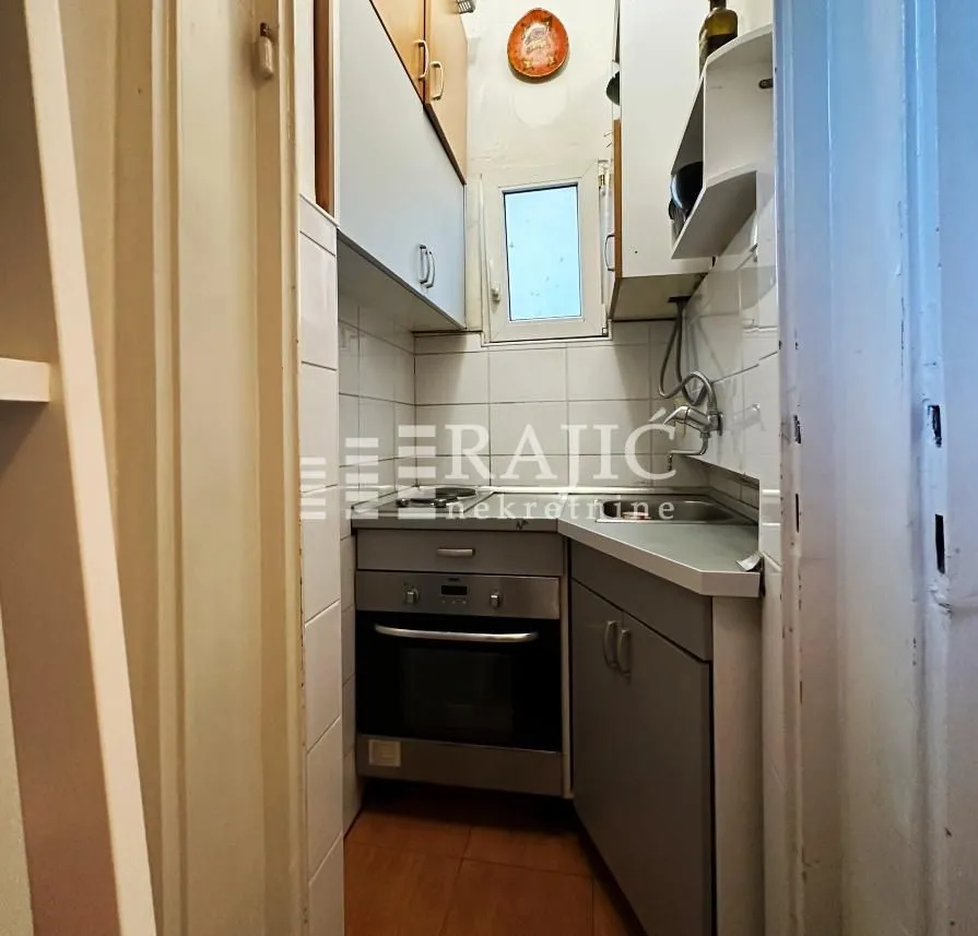 Small kitchen with built-in cabinetry and appliances.