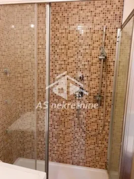 Walk-in shower enclosure with mosaic tiles and glass screen. - image 14