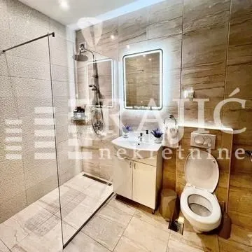 Modern bathroom equipped with a walk-in shower and vanity.