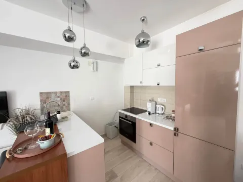 Modern kitchen with a breakfast bar and built-in elements in pastel tones. - image 5