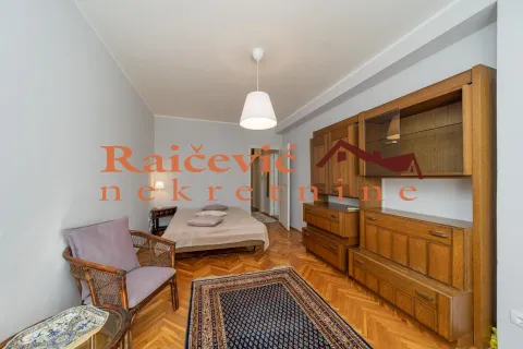Furnished bedroom with a double bed, wooden wardrobes, and parquet flooring. - image 14