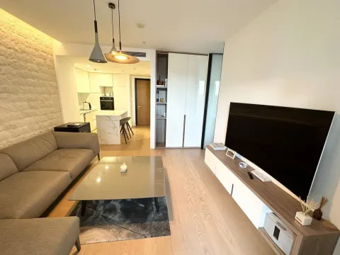 Modern and bright living room with a sofa and a view towards the kitchen. - image 5