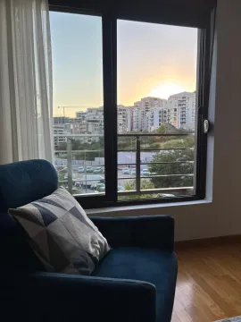 Comfortable armchair by the window with a city view. - image 8