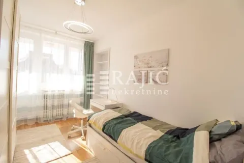 Furnished bedroom with a bed and a desk. - image 4