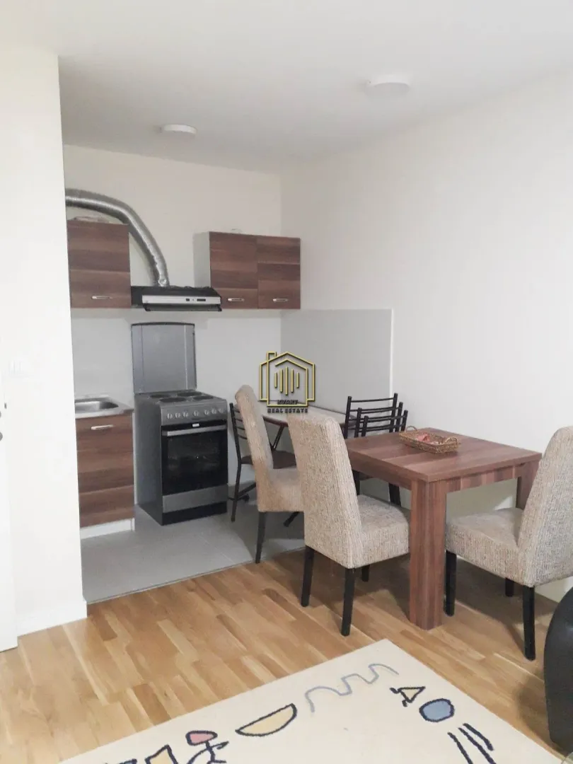 Small kitchen with a dining table and chairs as part of the living area.