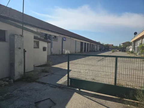 View of the exterior of a commercial building with a warehouse and a fenced yard. - image 2