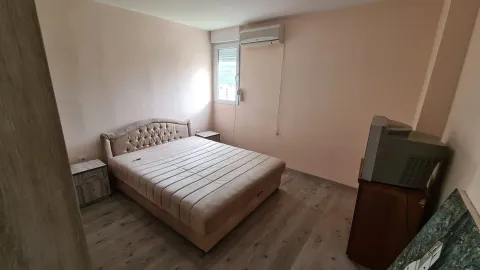 Bedroom with a double bed, nightstands, and an air conditioning unit. - image 9