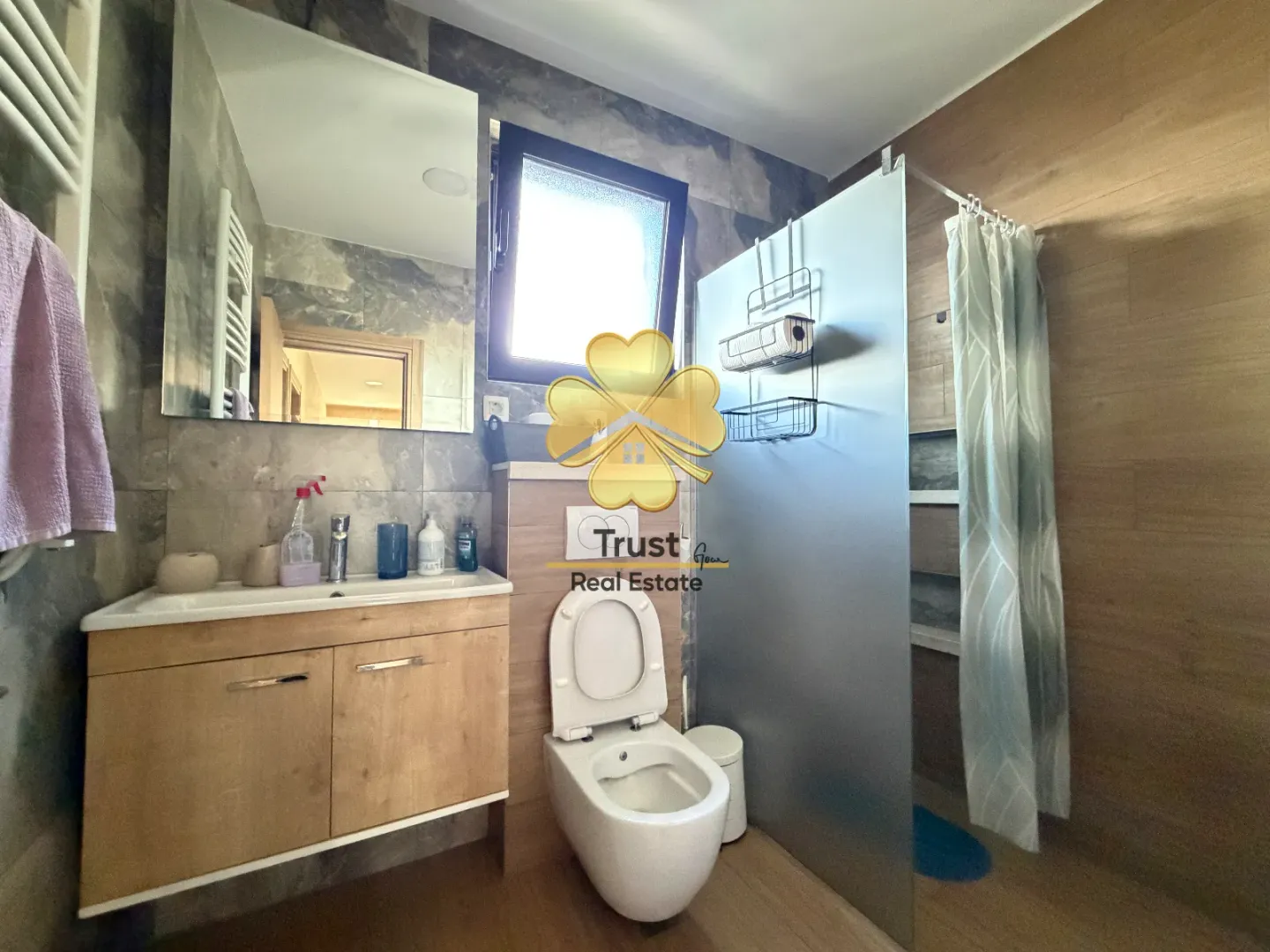 Modern bathroom with a vanity, toilet, and walk-in shower.