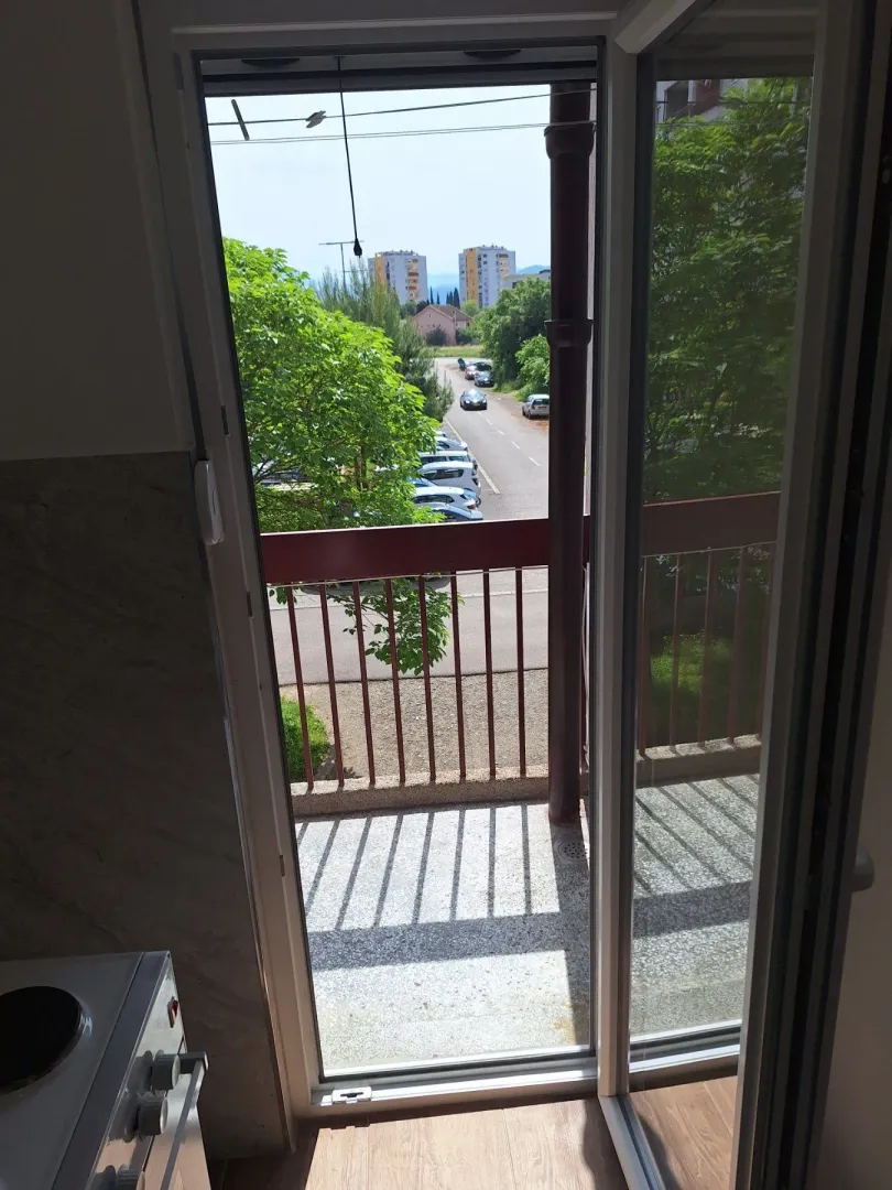 View from the balcony overlooking the street and surrounding buildings.