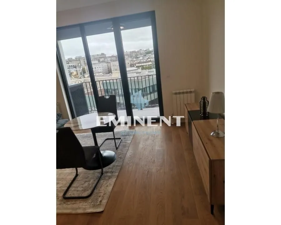 Living room with dining table and access to the terrace.