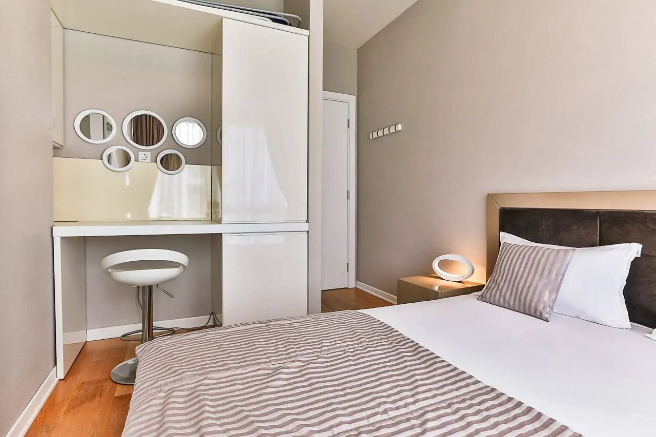 Modern bedroom with a double bed and a built-in wardrobe with a vanity desk.