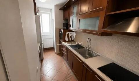 Small kitchen with wooden cabinetry and built-in appliances. - image 5