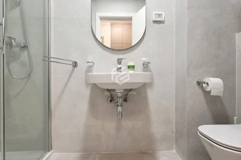 Modern bathroom with a sink, shower cabin, mirror, and toilet bowl. - image 4