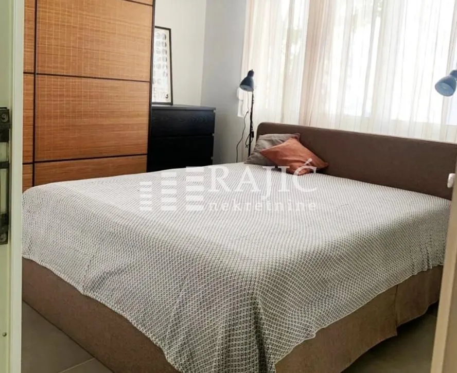 Furnished bedroom with a double bed and wardrobe.