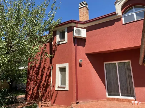 Exterior of a house with a red facade and a tiled yard. - image 4