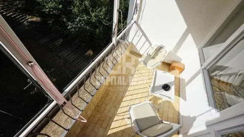 Small enclosed balcony space with chairs and a table. - image 15