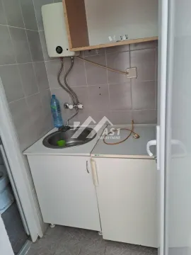 Small kitchen with a sink, base cabinets, and a water heater on the wall. - image 6