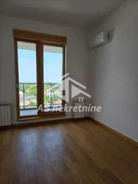 Empty room with wooden flooring, air conditioning unit, and balcony doors. - image 8