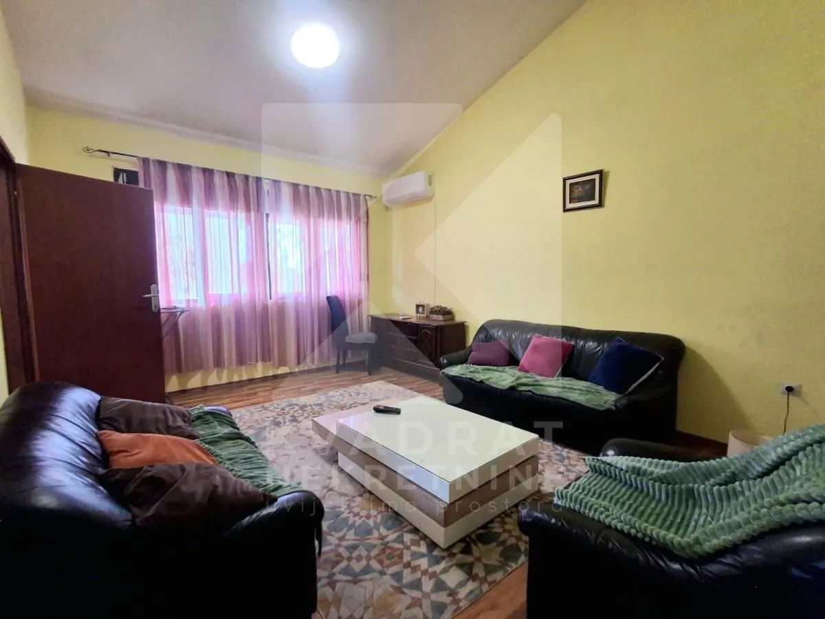 Dnevna soba sa garniturom za sedenje i stočićem.