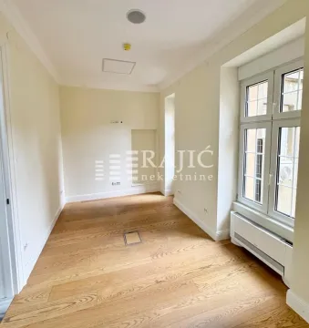 Empty room with wooden flooring and a window. - image 2