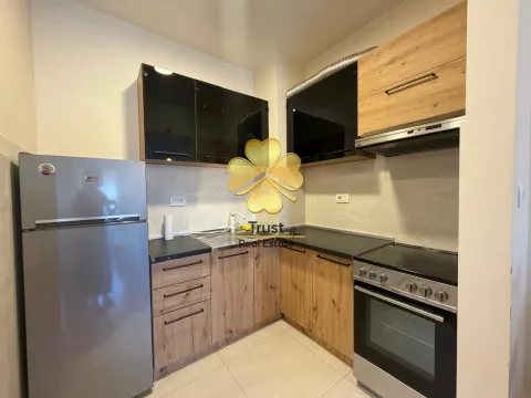Small kitchen with wooden elements, refrigerator, and stove. - image 7