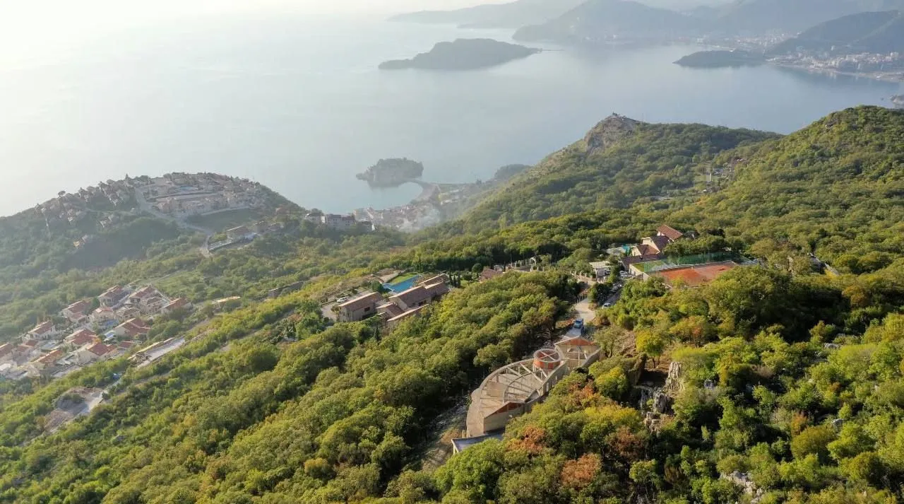 Pogled iz vazduha na obalu i brdoviti pejzaž.