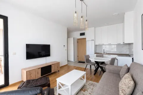 Modern living room with kitchen and dining area. - image 2