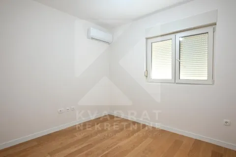 Empty room with white walls, wooden flooring, and an air conditioning unit. - image 9