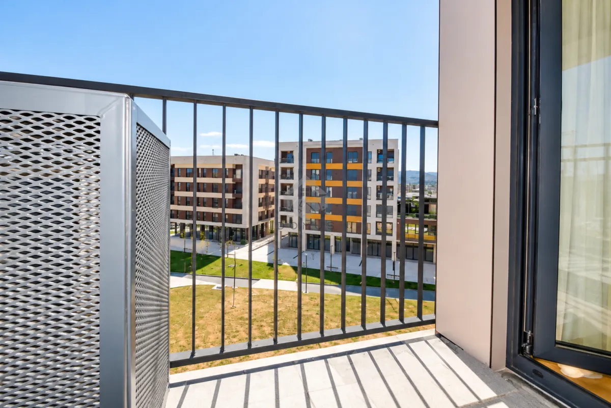View from the balcony overlooking surrounding residential buildings and courtyard.