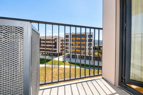 View from the balcony overlooking surrounding residential buildings and courtyard. - image 23