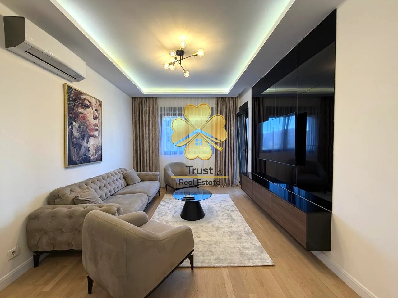 Modern living room with a sofa and TV unit.