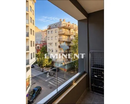 View from the balcony overlooking the city street and surrounding buildings. - image 8