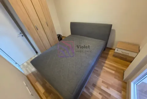 Furnished bedroom with a double bed, wardrobe, and bedside table. - image 11