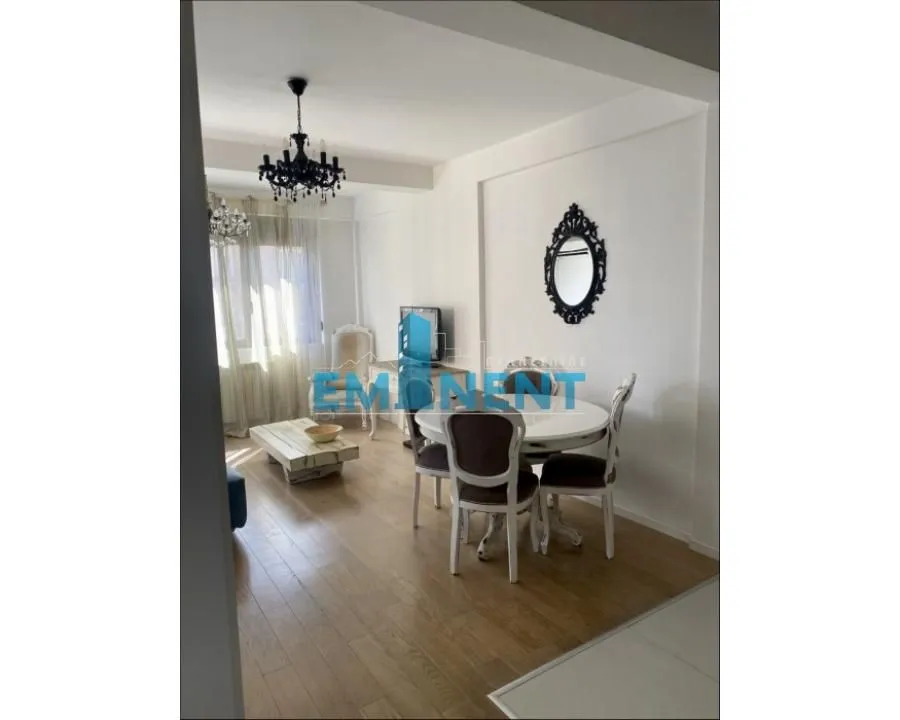 Living room with dining area, hardwood floors, and traditional furniture.