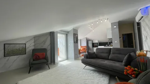 Spacious living room with a sofa set and a view of the kitchen. - image 3