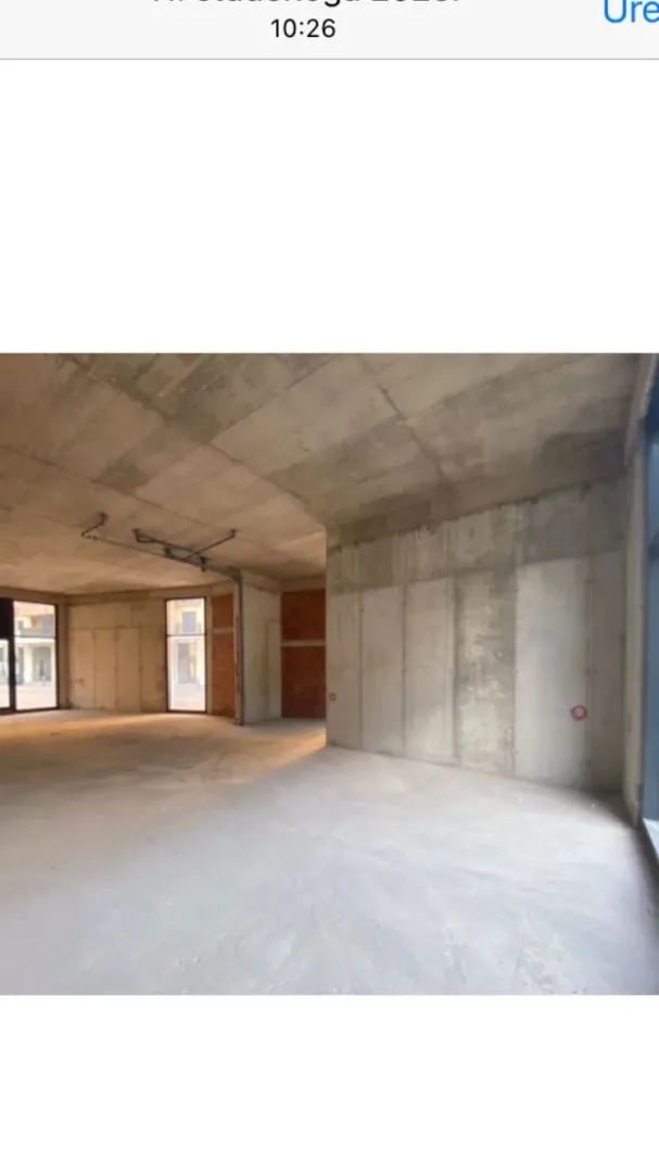 View of an empty space under construction with concrete walls and pillars.