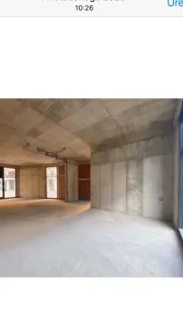 View of an empty space under construction with concrete walls and pillars. - image 8