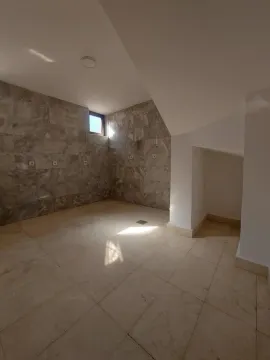 Empty bathroom with ceramic tiles and a small window. - image 4