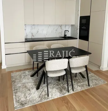 Modern kitchen with a dining table and built-in units. - image 3