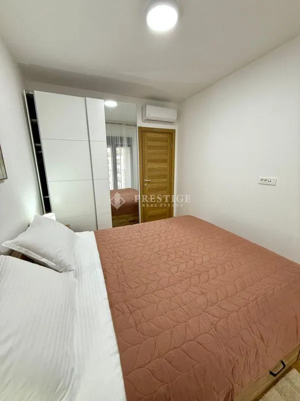 Bedroom with a double bed, wardrobe, and air conditioning.