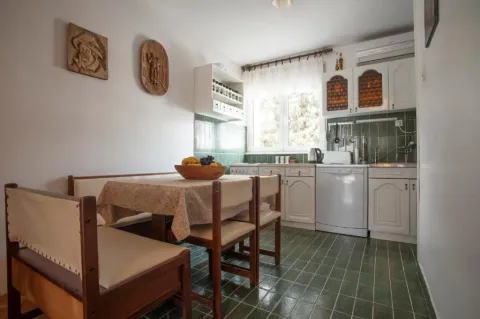 Smaller kitchen with a dining table and chairs. - image 14