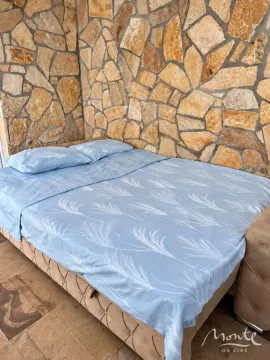 Krevet u spavaćoj sobi sa zidom od kamena. - image 7