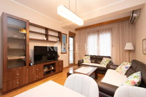 Living room with a sofa set, TV unit, and dining table. - image 14